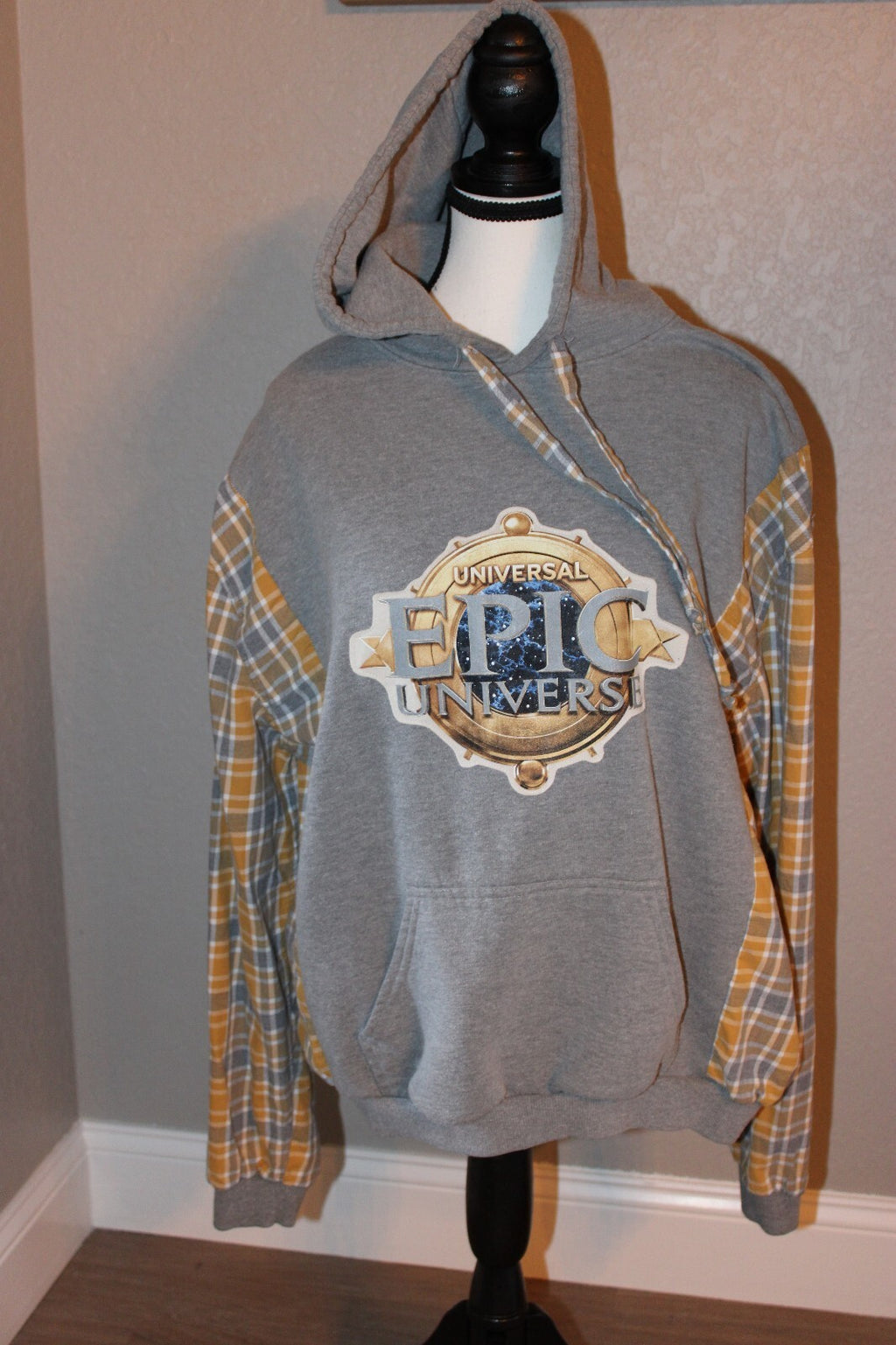 Universal Epic Universe Gray Hoodie with Yellow Plaid Sleeves and Front Pocket