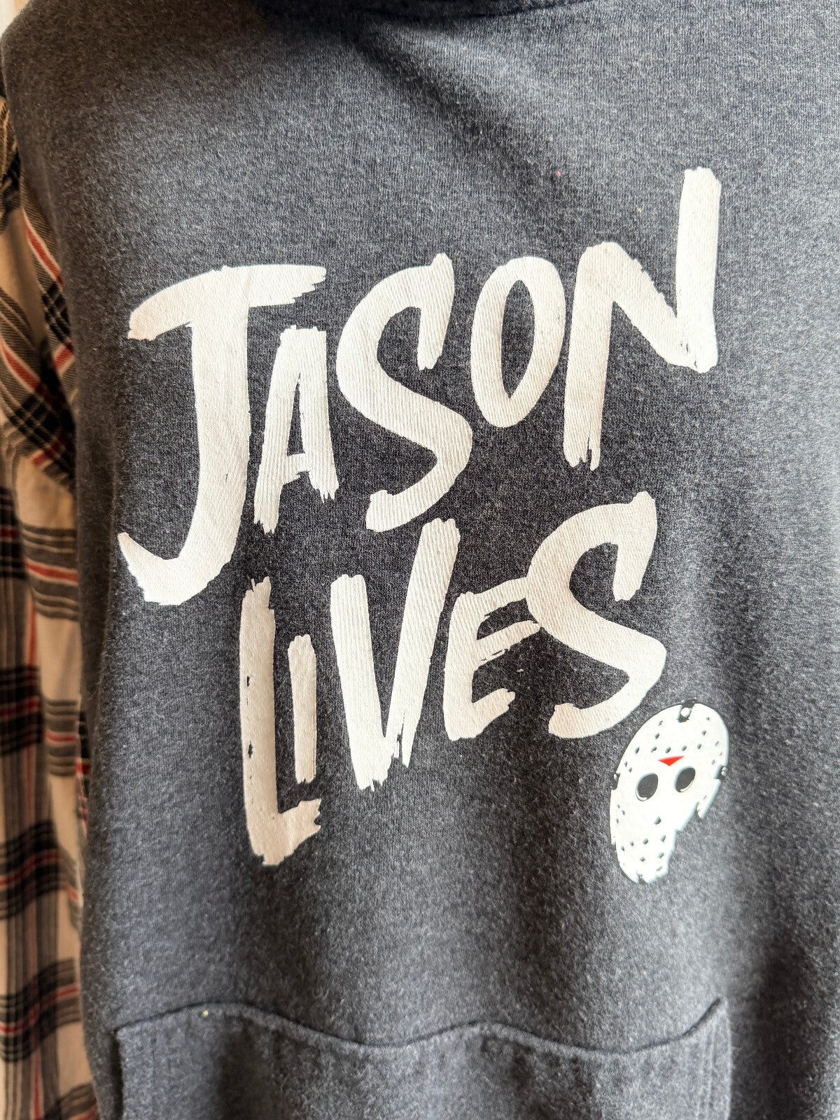 Jason Lives Graphic Hoodie with Plaid Sleeves and Hooded Collar.